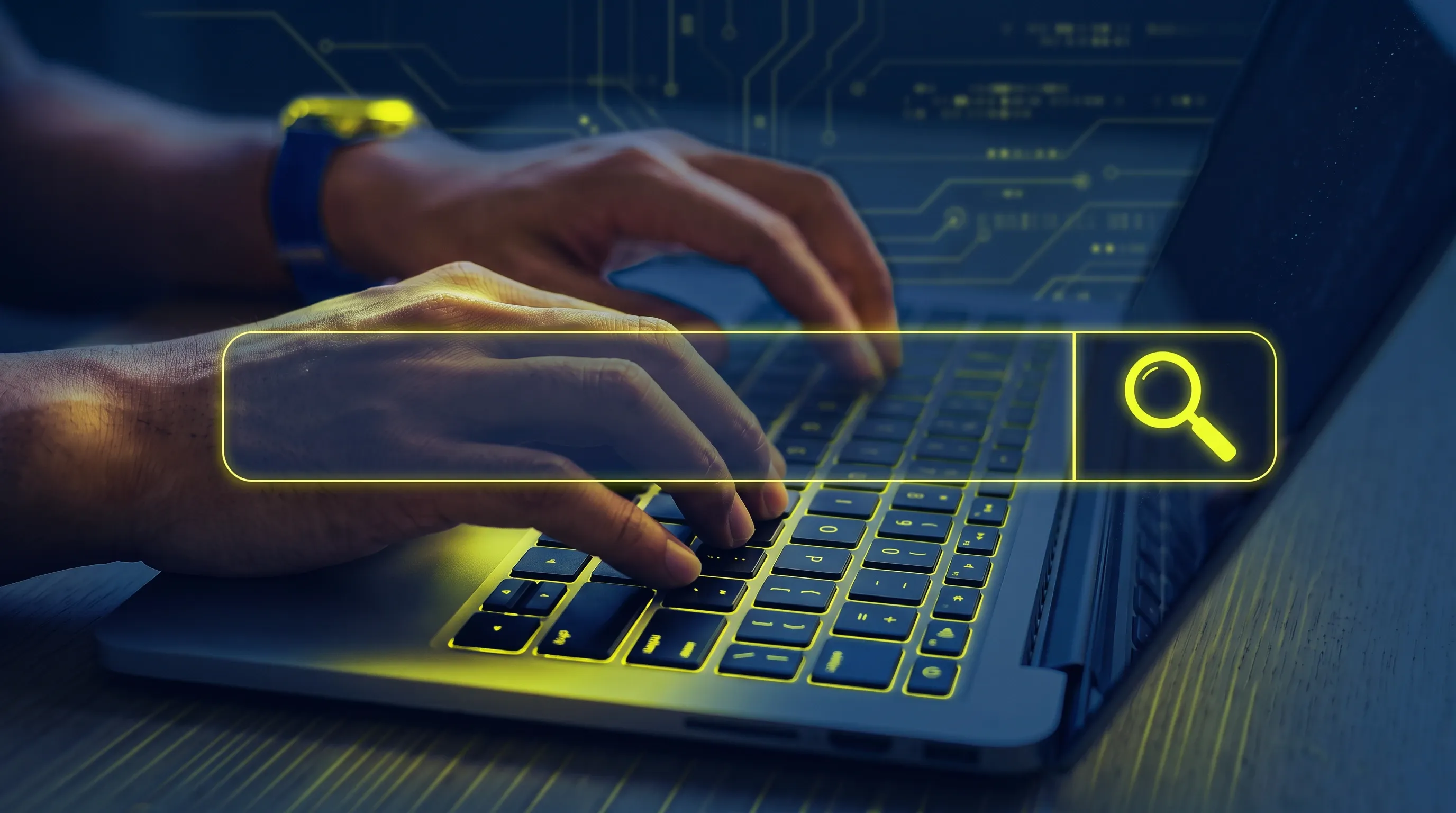 A close-up of a person’s hands typing on a laptop keyboard.
