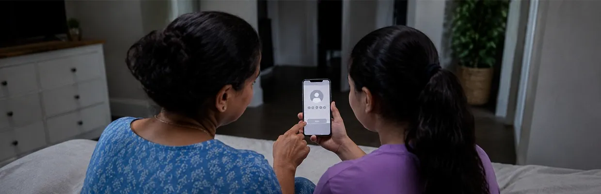 A mom and daughter using a phone